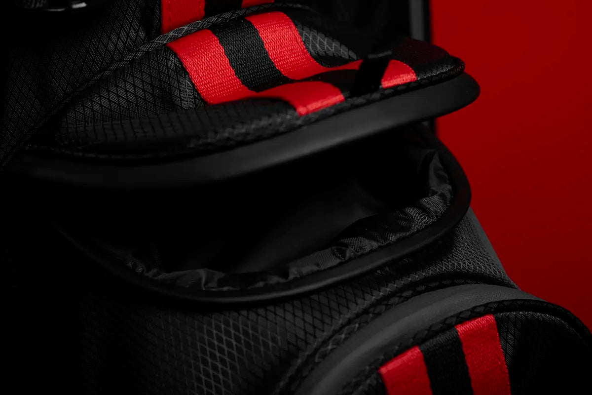 Showcasing The Explorer black stand bag's magnetic closure pocket, designed for fast and easy access.