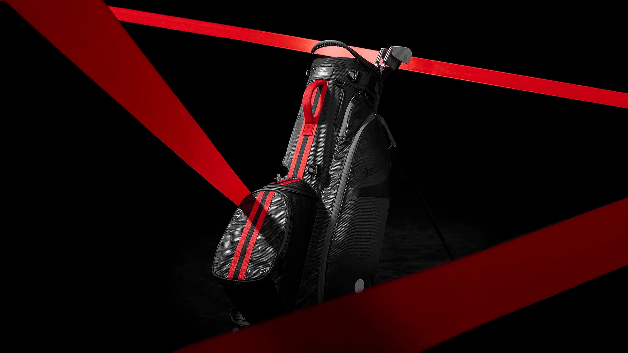 Linkslite The Explorer black golf stand bag with red accents displayed in a hero banner on a black background.